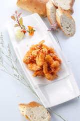 French style sizzling salt and pepper shrimp on a white porcelain plate