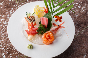 Japanese sashimi assortment on a white porcelain plate