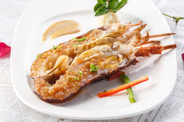 Pan-fried Australian lobster with garlic sauce on a white porcelain plate