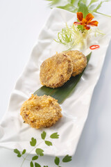 Deep-fried golden beef patties served in exquisite tableware