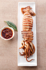 Japanese squid grilled on a plate with exquisite tableware