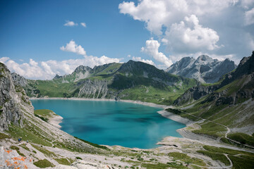 Turquoise lake nestled in the European alps during summer