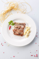 French-style grilled garlic and pepper beef short ribs in exquisite tableware
