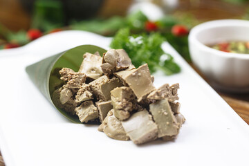 Pork liver with sauce in rectangular white porcelain plate