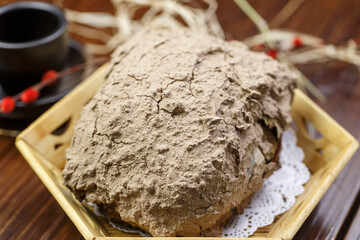 Traditional beggar's chicken in a hexagonal bamboo basket