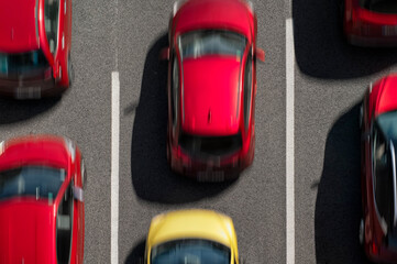 One yellow car among red ones