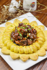 Pork short ribs in a square white porcelain plate
