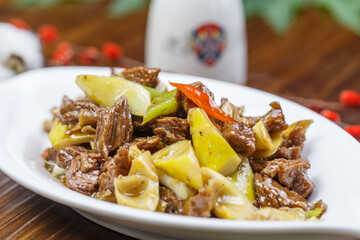 Stir-fried pork with spring bamboo shoots in a leaf-shaped porcelain plate