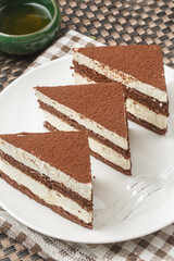 Chocolate dusted cream mousse on tablecloth