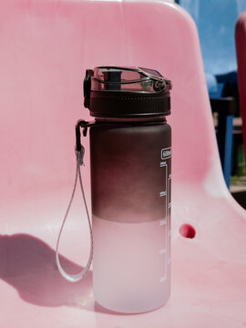 Reusable water bottle on the pink seat with space for text