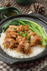 Cordyceps flower pork ribs porridge in a black casserole placed on the tablecloth