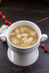 Cordyceps flower pig's trotter soup in white porcelain soup bowl