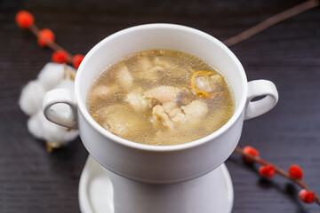 Cordyceps flower pig's trotter soup in white porcelain soup bowl