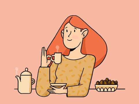 Woman drinking tea or coffee and holding a small bowl