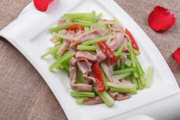 White fan-shaped disk of fried sea sausage with celery