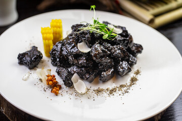 Baked beef brisket with cuttlefish ink Accessories: corn, kumquat, sea buckthorn fruit