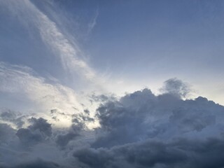 Evening sunset – White and dark clouds illuminated by the last remaining rays of the evening sun,...