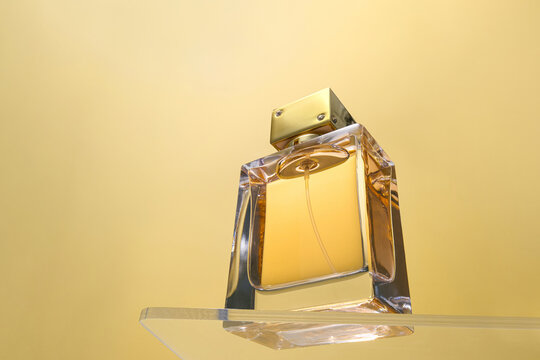 A close-up of a sophisticated perfume bottle on golden background