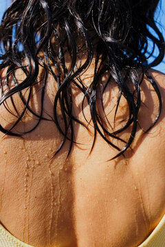 Wet hair falling on back during a summer heatwave