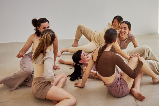 Women enjoying movement and laughter in a dance session