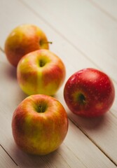 Fresh red apples on wooden table
