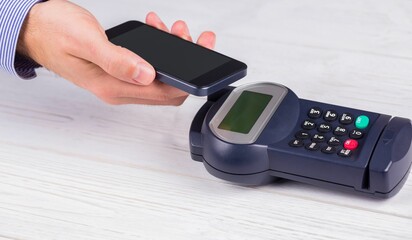 Man using smartphone to express pay