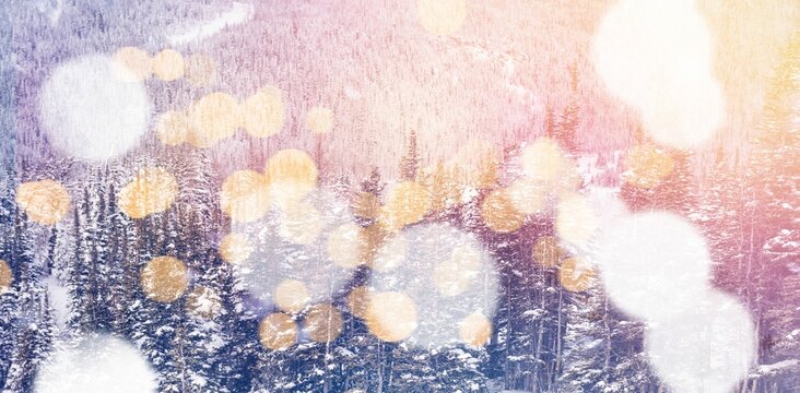 Fototapeta Defocused lights against snow covered trees and mountain