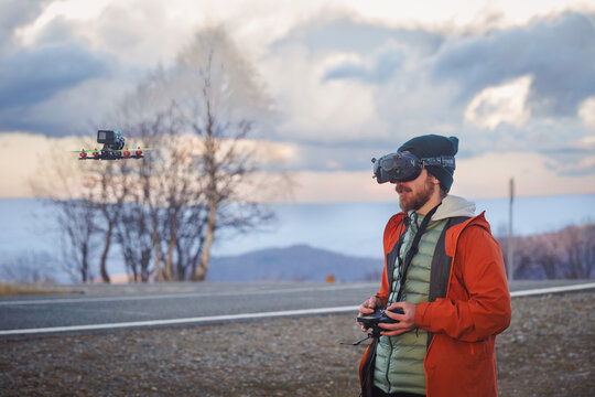 FPV drone pilot in scenic mountain landscape