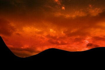 Silhouetted rolling hills are rising against dramatic red and orange cloudscape sky in flat design