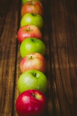 Red and green apples on table
