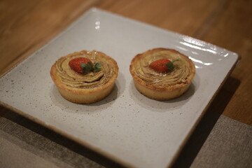 Strawberry-Topped Round Pastries on a Square Plate