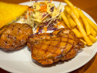 Pork steak with potato fried and salad on the table