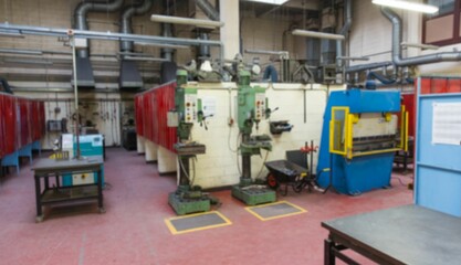 Green drill presses are standing in flat design workshop, showcasing blue press and red partitions