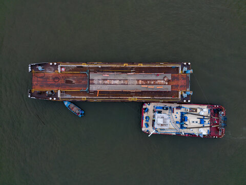 Top View of Industrial Barge and Workboat on River