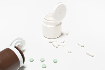Green and White Pills on White Background