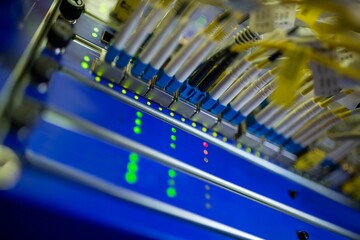 Rack-mounted fiber-optic patch panel is showing in flat-style with blue yellow cables, glowing LEDs