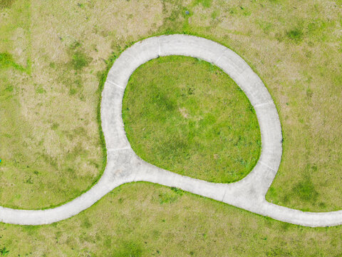 Aerial Curved Road Loop Teardrop Shape Green Grassland