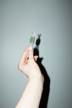 Hand holding colourful wrapped sugar sweet candy with flashlight