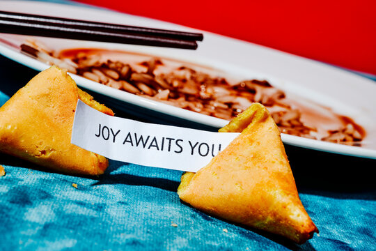 open fortune cookie with the message joy awaits you