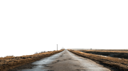 A long, empty road stretching into the distance against a clear sky.