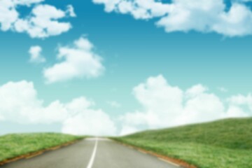 Road amidst by green grassy field