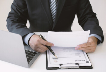 Businesswoman holds a resume and evaluates it. Views the personal history of job applicants. Recruitment concept