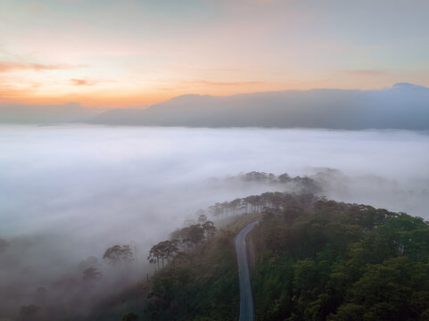 Misty landscapes of Lac Duong at dawn with winding roads and sof