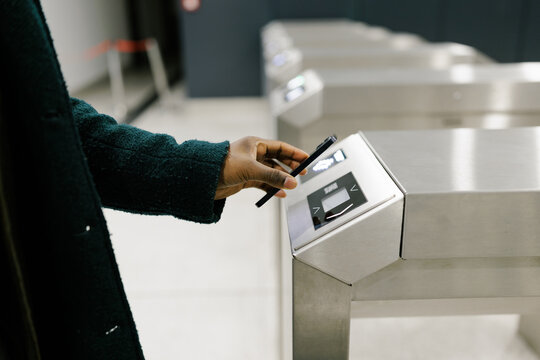Close up on Hand Using Phone for Ticket Scanner at Subway Entrance 