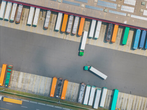 Aerial View of Colorful Truck Trailers in a Logistics Warehouse 