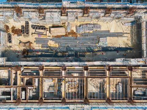 Aerial Construction Site with Steel Framework and Crew
