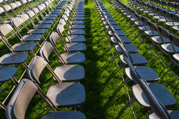 Rows of empty chairs at college graduation ceremony