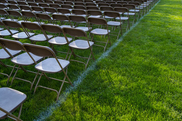 Rows of empty chairs at college graduation ceremony