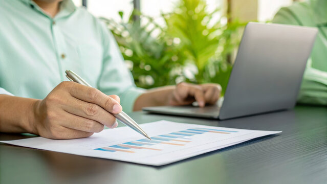 Sustainable business green environmental. Businessperson, chart, pen, laptop, and green plant create modern eco friendly . Environment, earth day, corporate, development, eco friendly, save energy