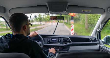 Rainy road. Wet view. Driver in action.